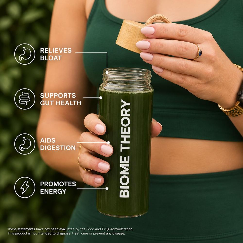 Woman holding a Biome Theory bottle of green drink, labelled for bloat, gut health, digestion and energy support